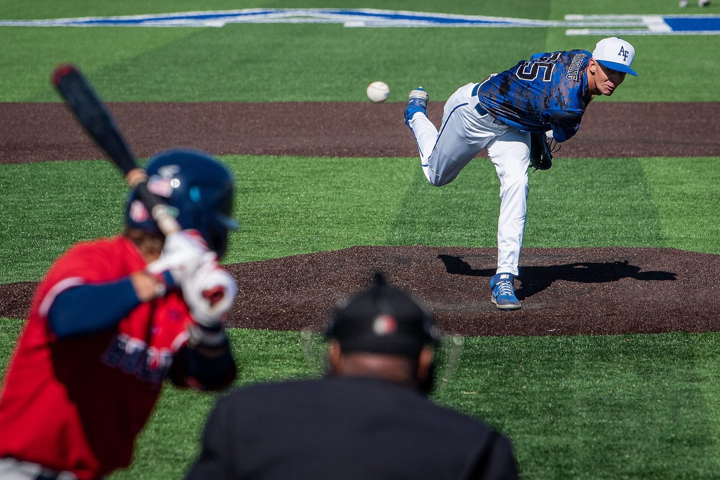 Baseball pitcher mid-throw